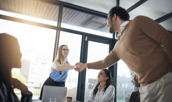 people at work shaking hands