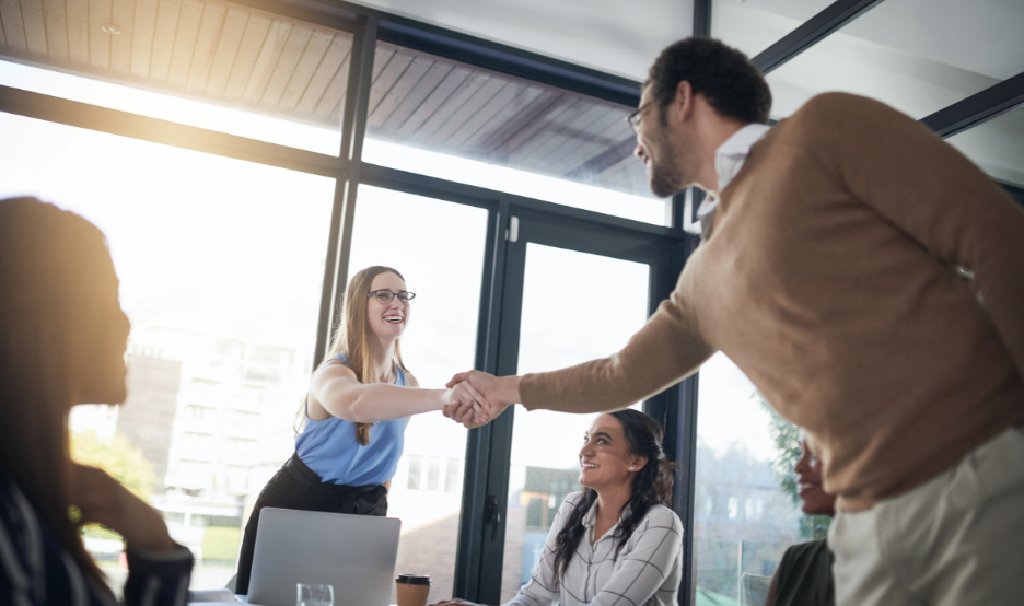 people at work shaking hands